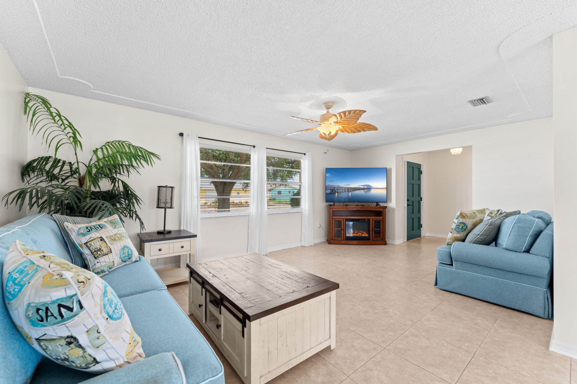 Bright living room with coastal furnishings and large windows