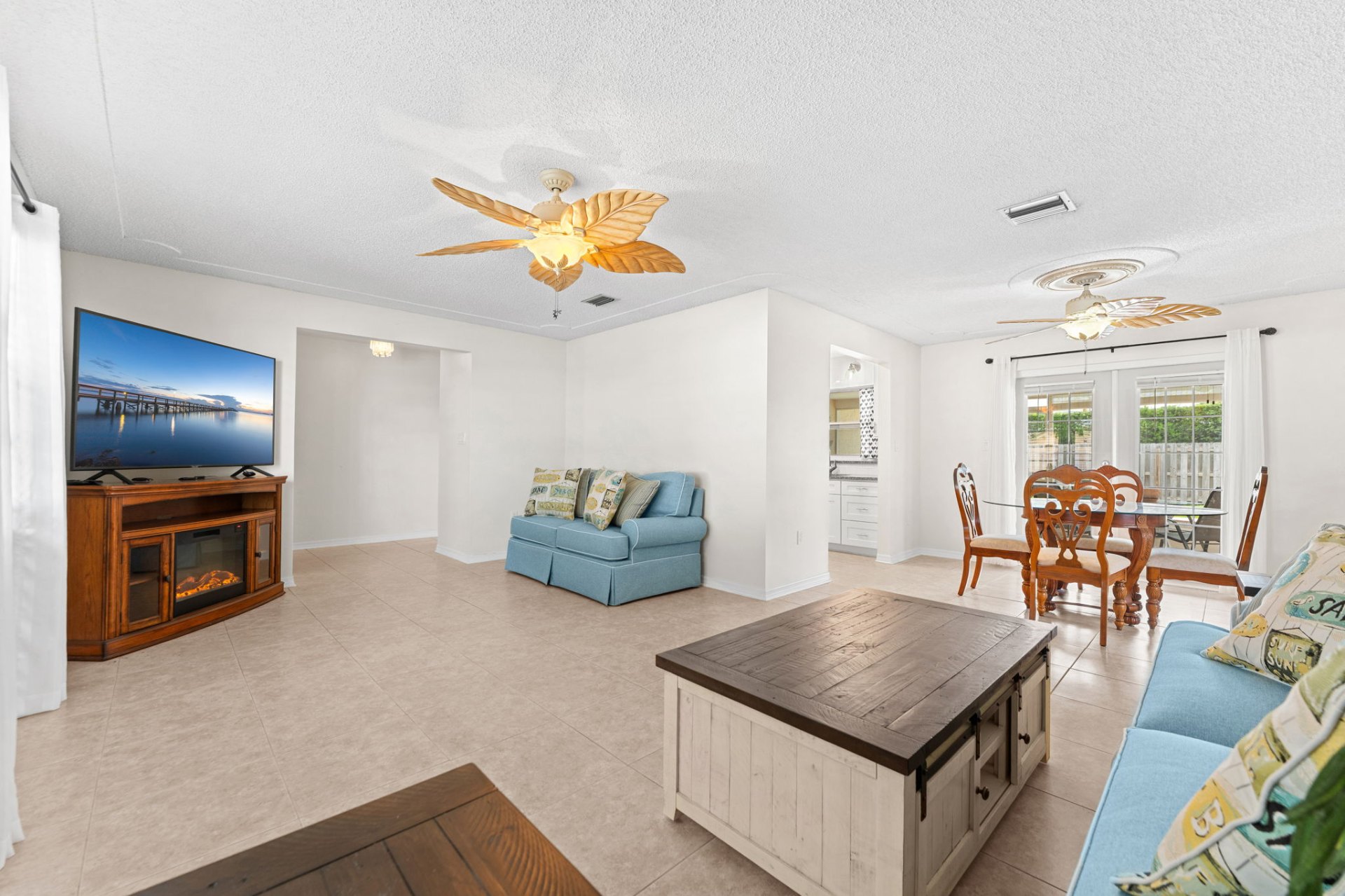 Family room with electric fireplace, dining area and slider to backyard