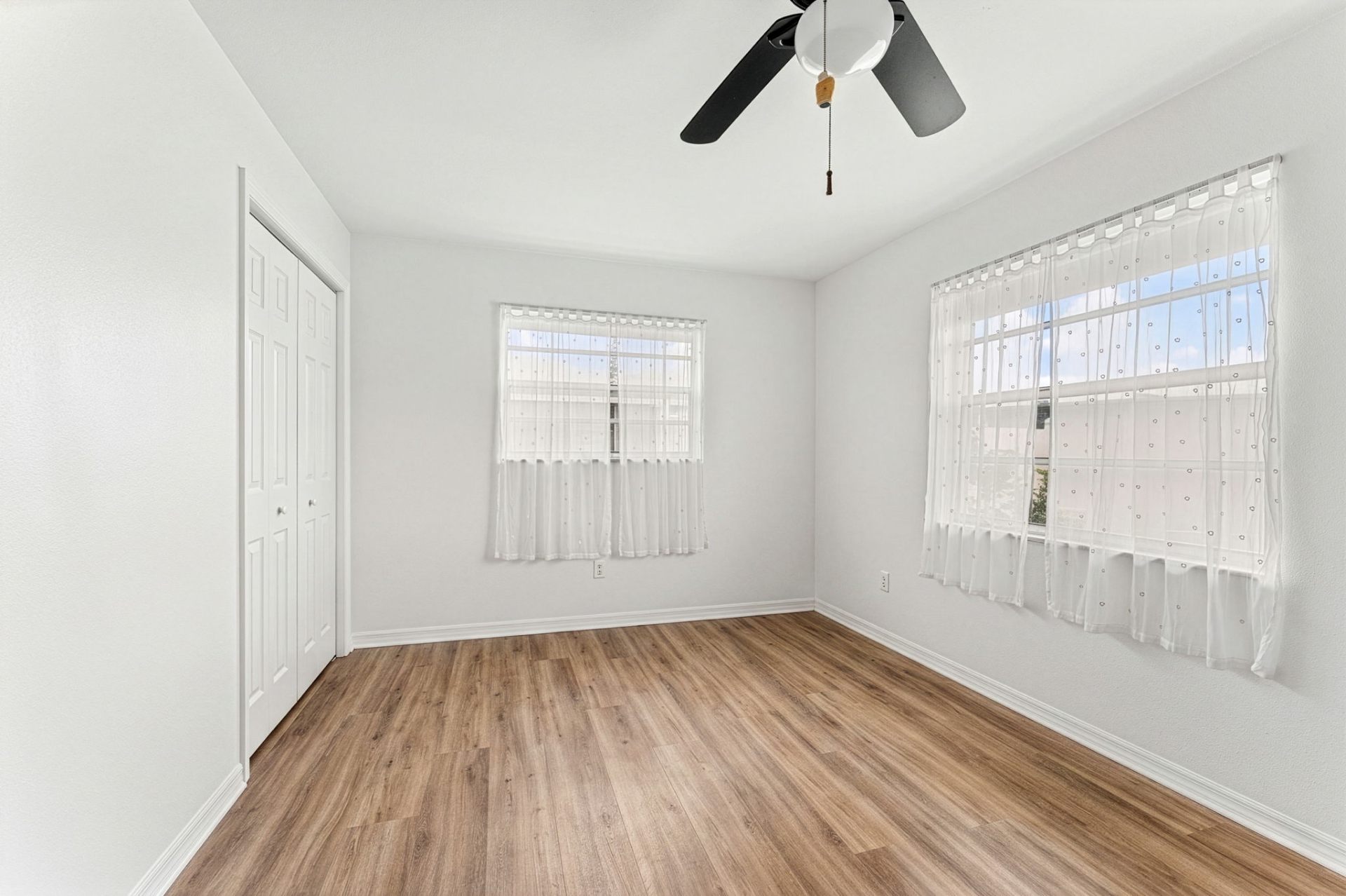 Third bedroom — bright, freshly painted, with new flooring