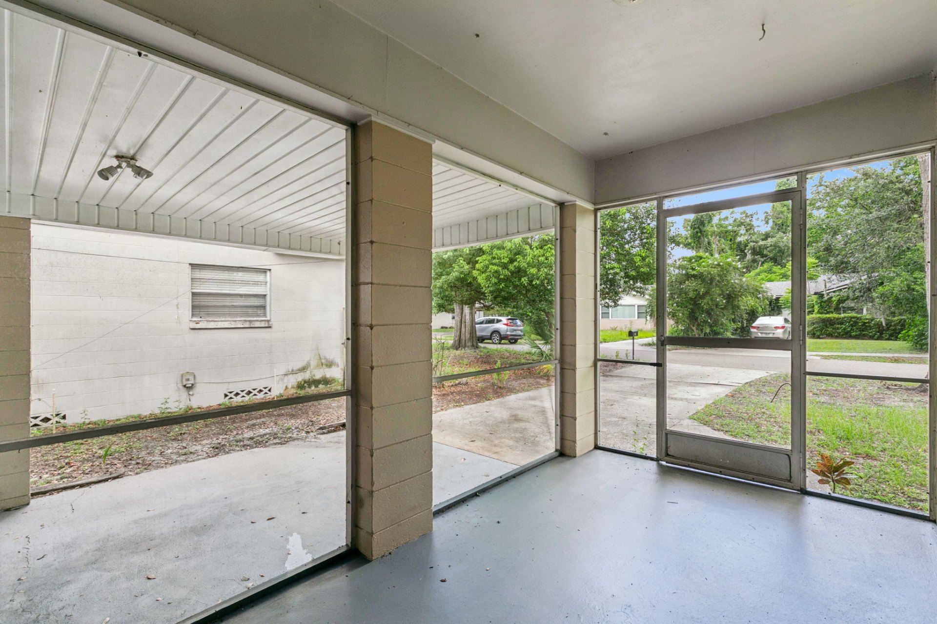 View from the screened front porch across the front yard to oak-shaded Driver Avenue
