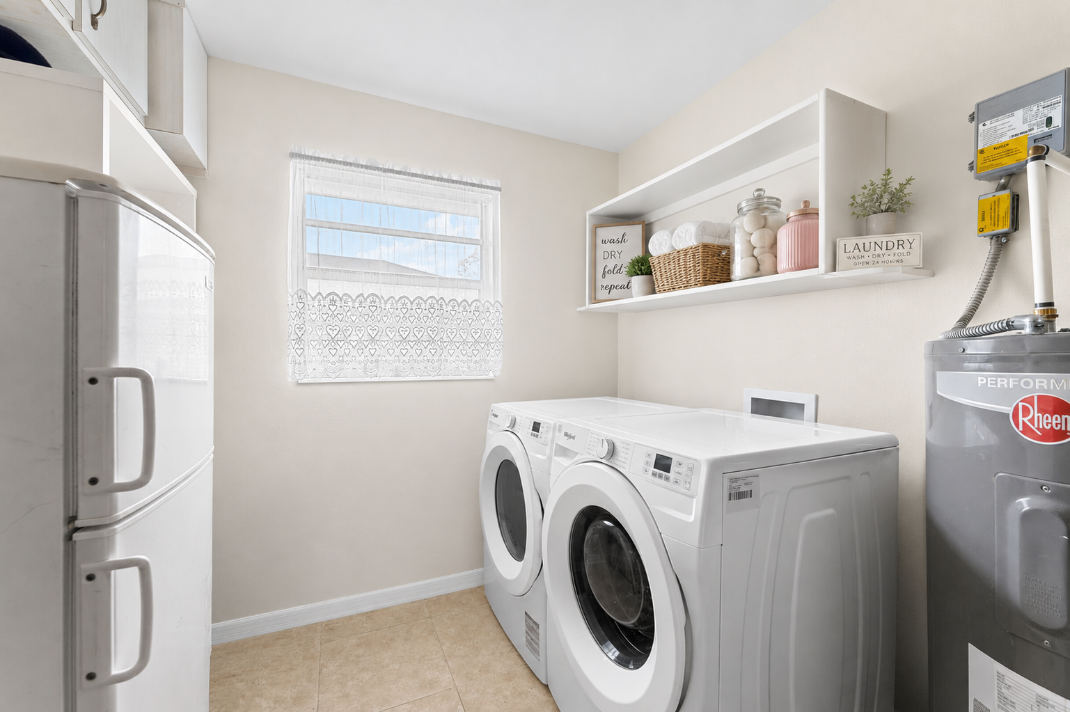 Interior laundry room with full-size washer and dryer