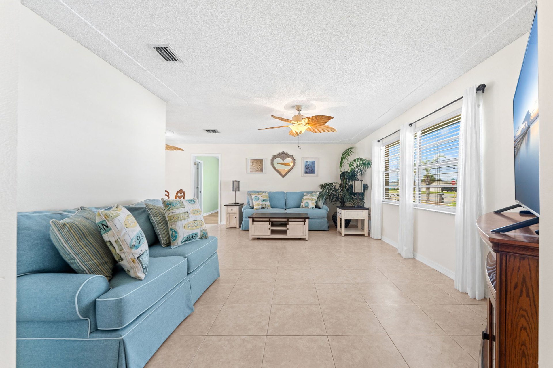 Spacious living room with twin sofas and street-facing windows