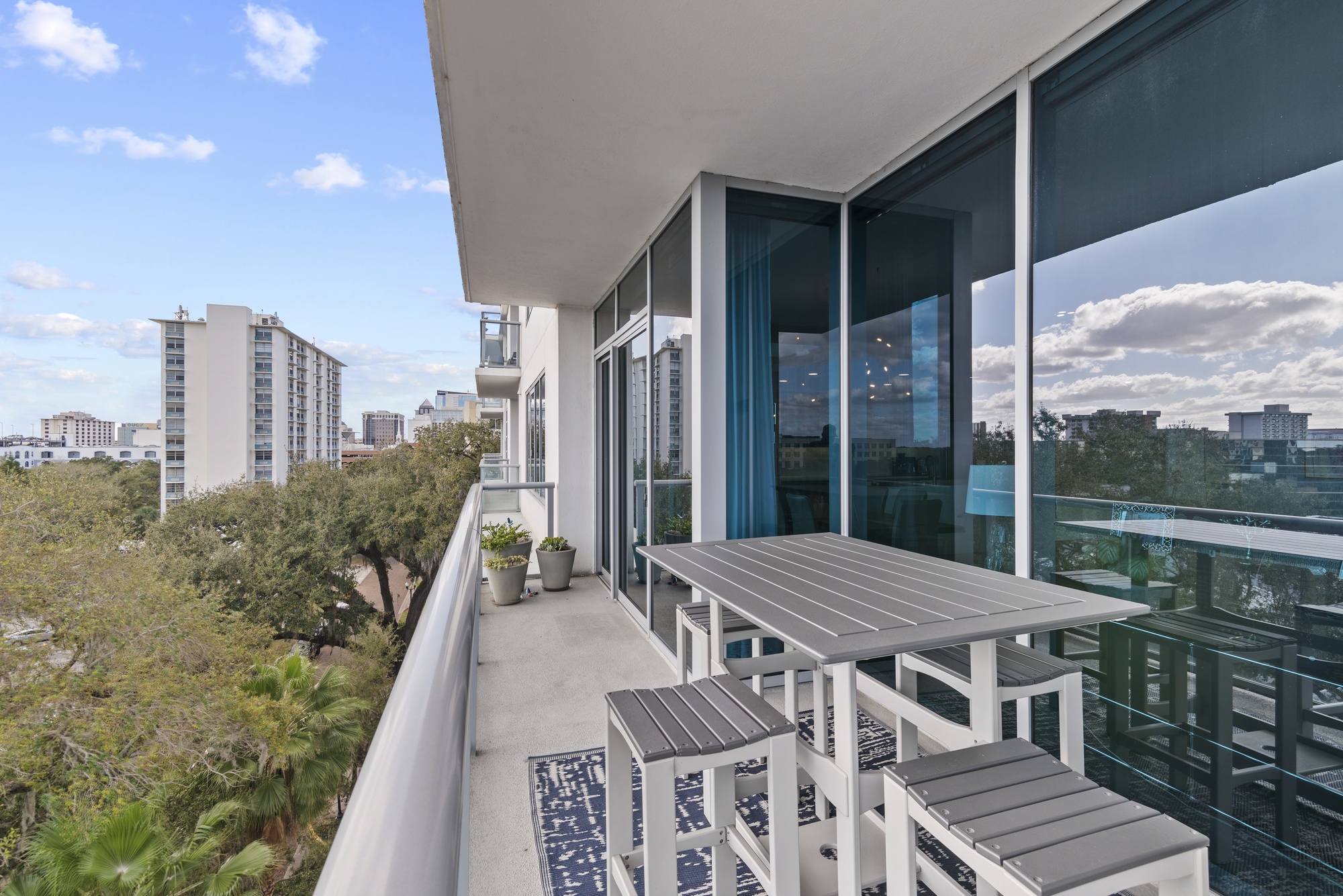 Exterior of a Florida condominium building with balconies and palm trees