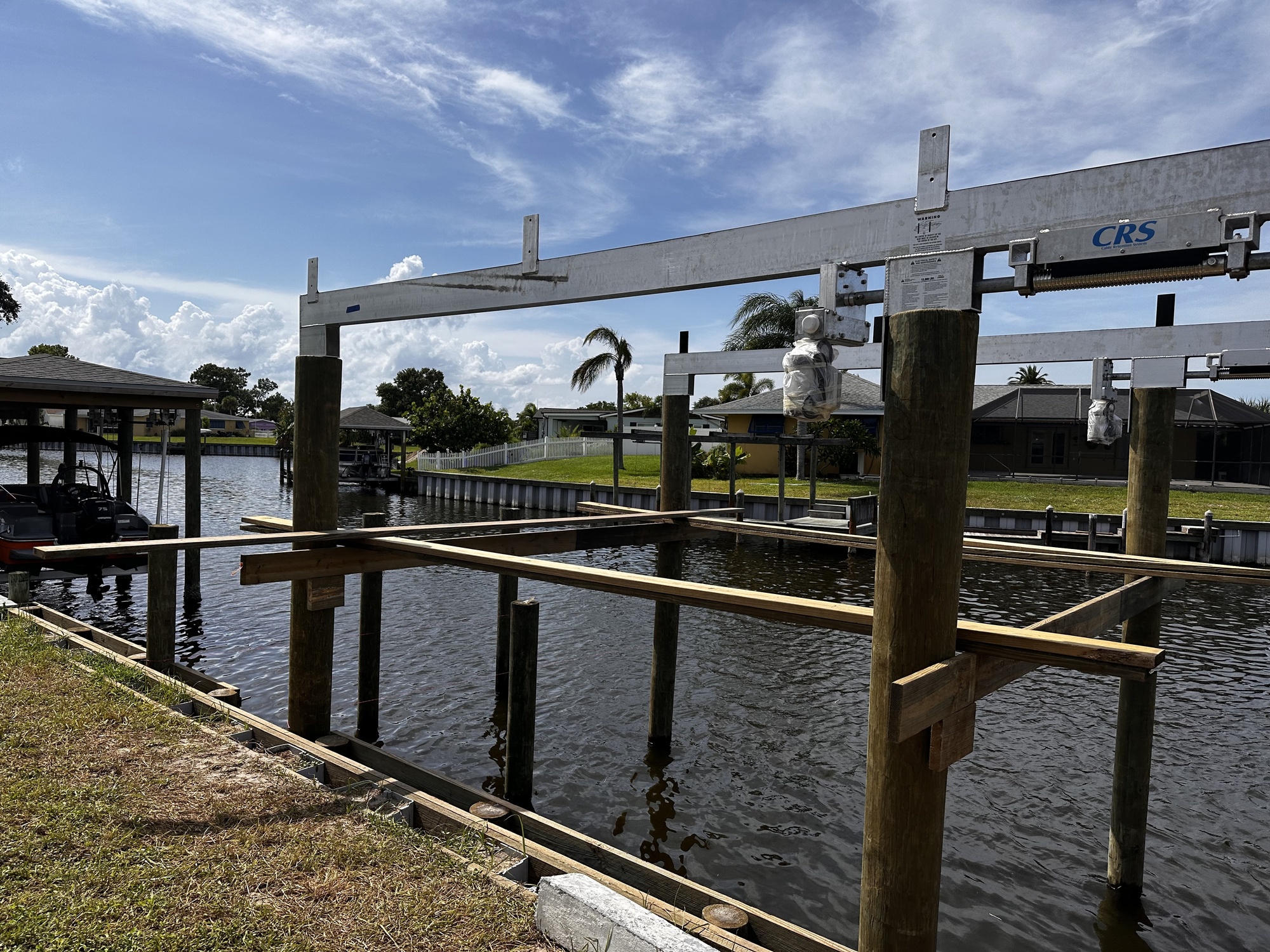 New dock and boat lift under construction at a Diana Shores canal-front home